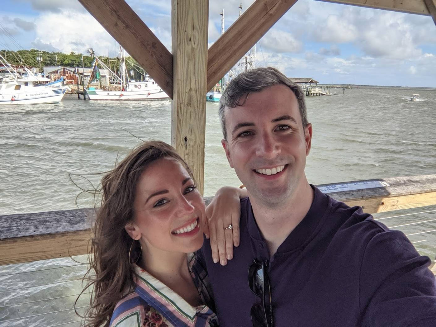 Henne Engagement Ring Couple Matthew & Dana Smiling While Overlooking the Water