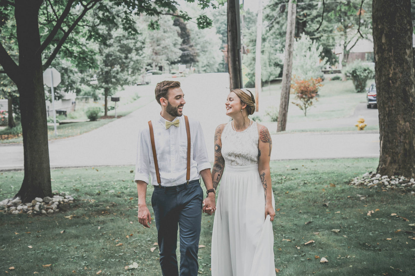 Henne Engagement Ring Couple Ian and Katey Walking Outdoors on Their Wedding Day