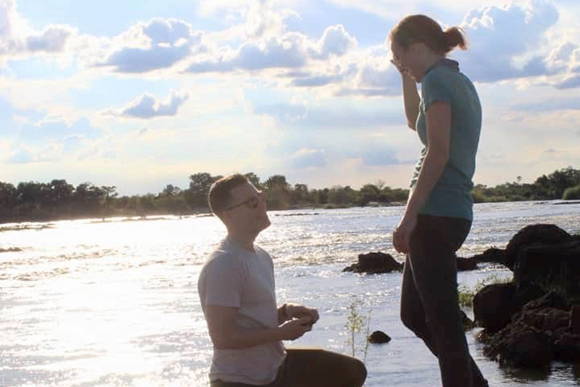 Bradley Proposing to Molly With an Engagement Ring from Henne Jewelers With the Zambezi River In the Background