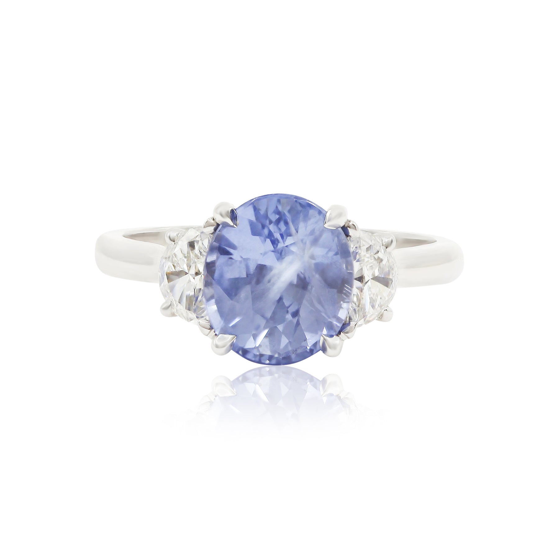 114K WHITE GOLD OVAL BLUE SAPPHIRE AND HALF-MOON DIAMOND THREE-STONE RING